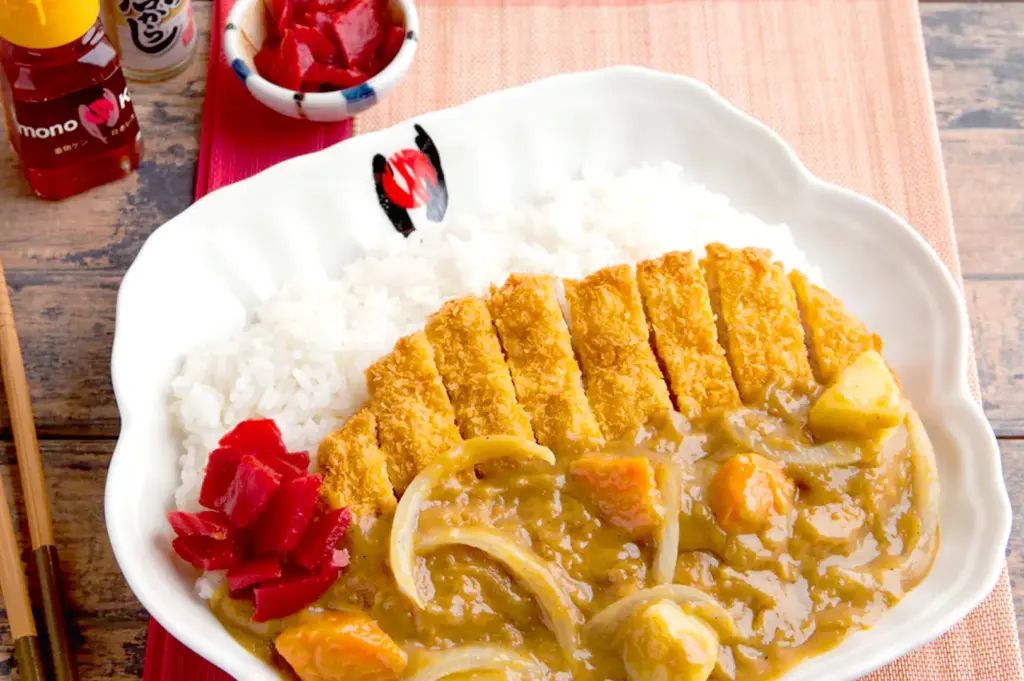 Japanese katsu curry with rice and pickled ginger.