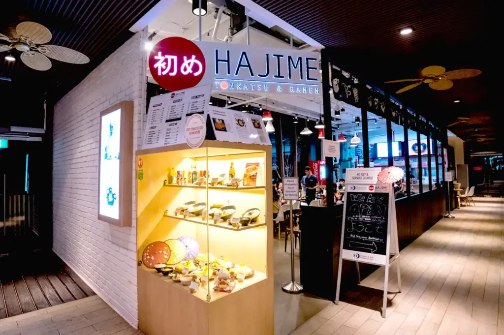 Japanese ramen restaurant storefront with illuminated sign.