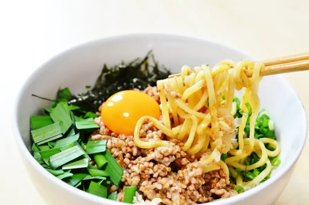 Mazesoba dry ramen with minced pork and egg yolk served in a Singapore izakaya