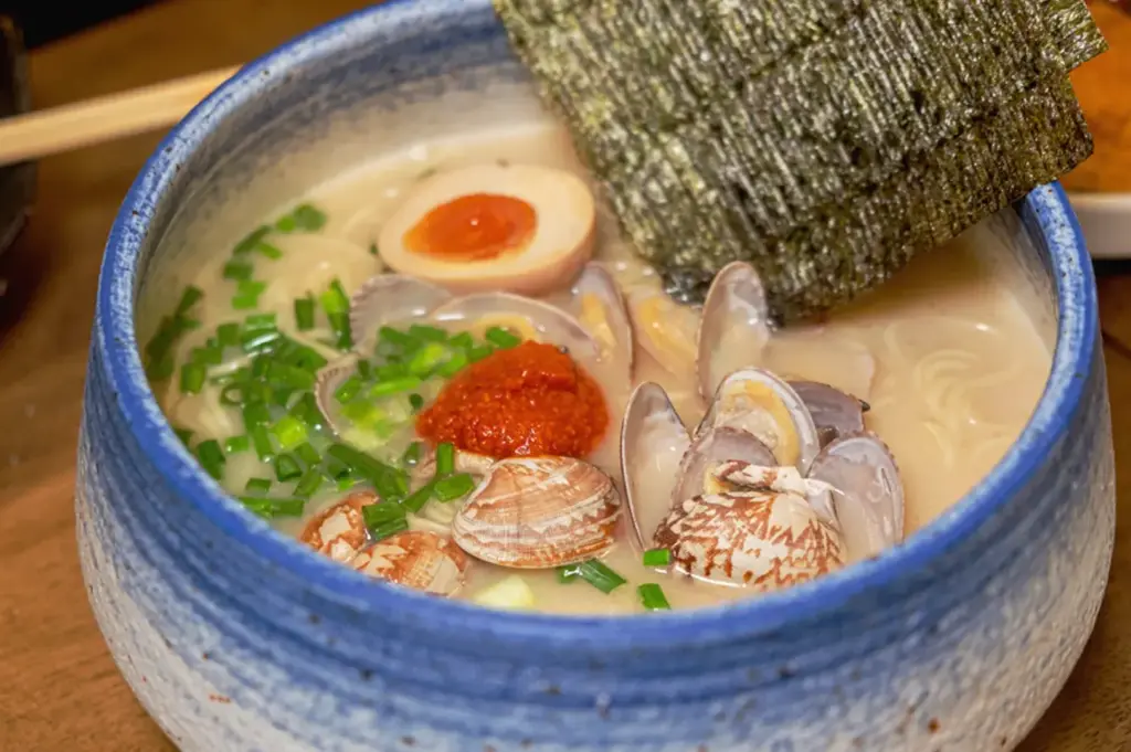 Japanese clam ramen in Singapore with rich broth, ajitsuke tamago, seaweed, and fresh shellfish