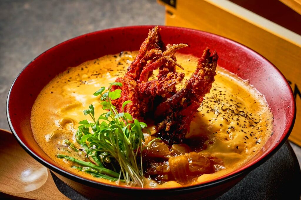 Chili crab ramen Singapore with crispy soft shell crab in rich spicy seafood broth