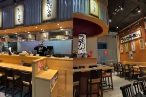 Ramen restaurant interior with counter seating and open kitchen.