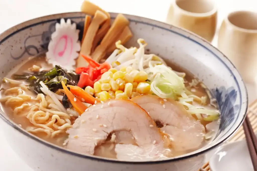 Miso ramen with vegetables, chashu pork, bean sprouts, corn, and narutomaki.