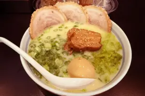 Chicken paitan ramen with chashu, soft-boiled egg, and scallions.