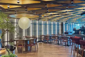 Mensho dining room with circular ceiling panels and wooden tables