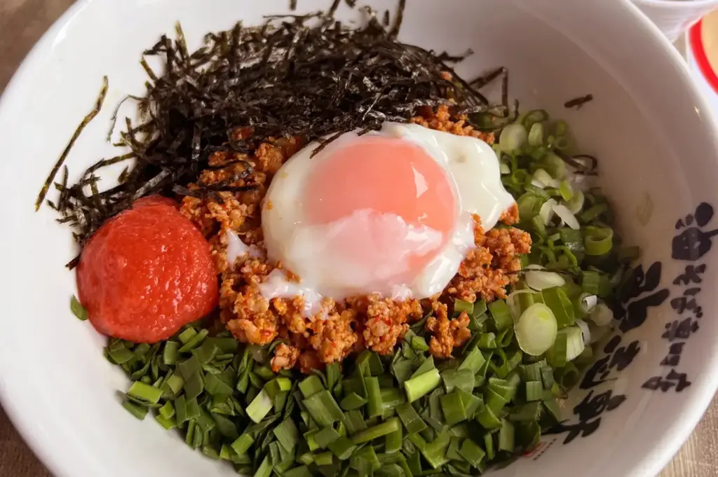 Mazesoba bowl with poached egg, nori, and scallions