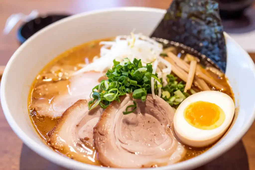 Tonkotsu ramen with creamy broth, chashu pork, soft-boiled egg, scallions, and nori.