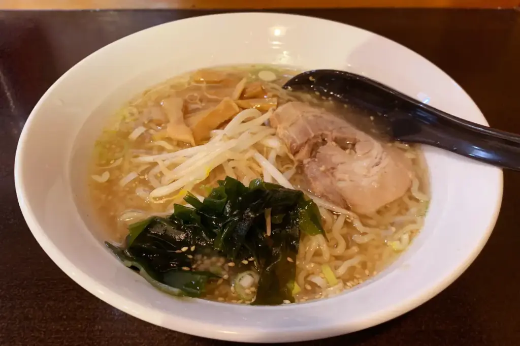 Shio ramen with clear broth, chashu pork, bean sprouts, seaweed, and bamboo shoots.