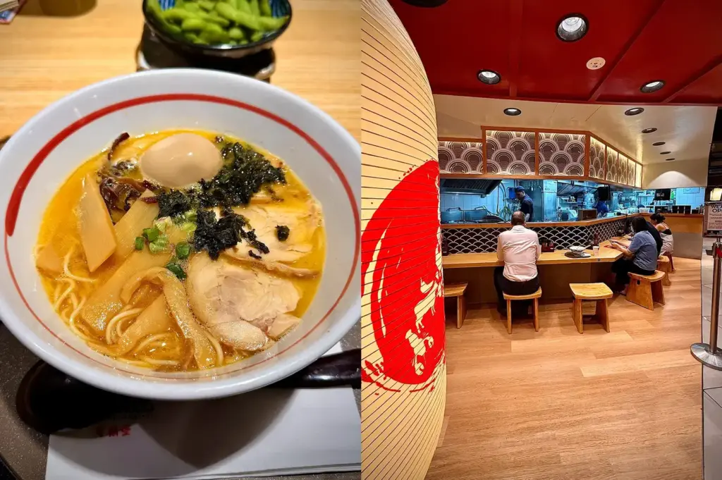 Bowl of Hokkaido ramen with egg, bamboo shoots, seaweed, and sliced pork beside the restaurant interior.